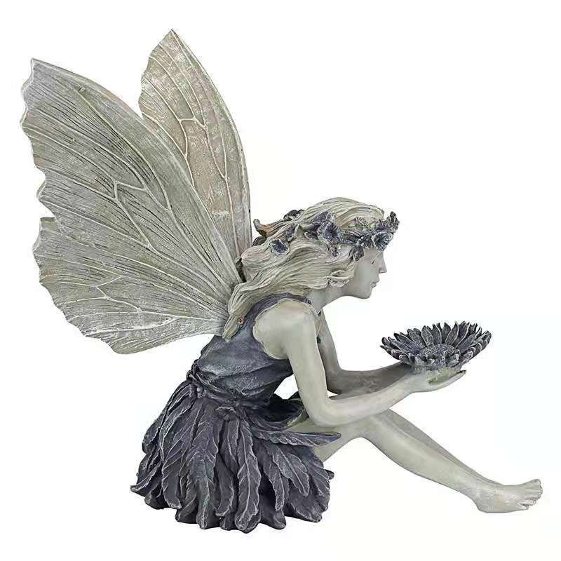 Decorative angel figurine as a birdbath for the garden