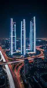 Neon Skyscrapers Above Night City Highway Light Trails