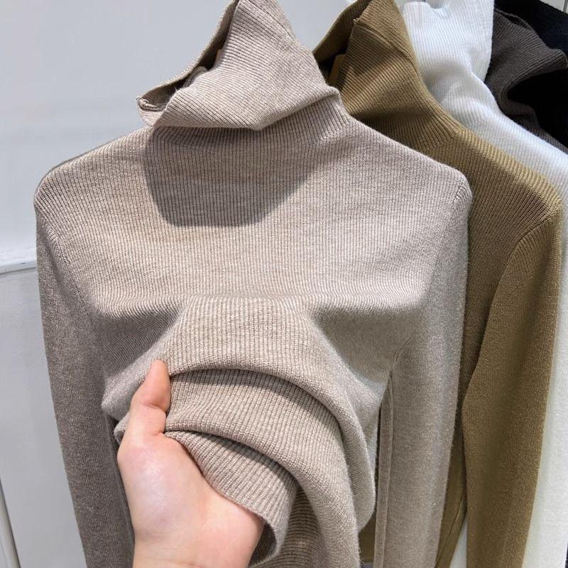 Slimming women's knitted sweater with a high collar