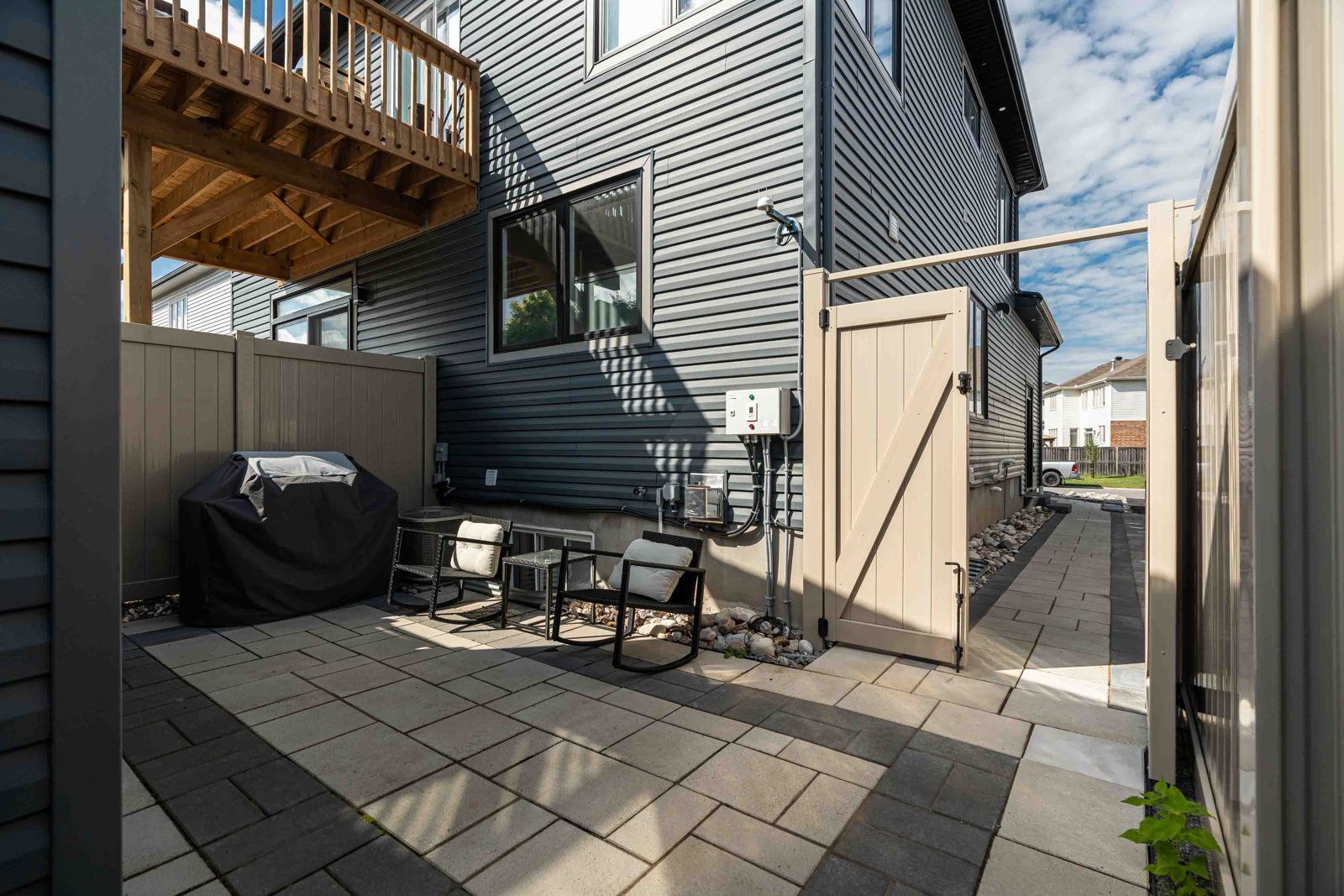 Side entrance and outdoor patio area at Charlebois Four Residences