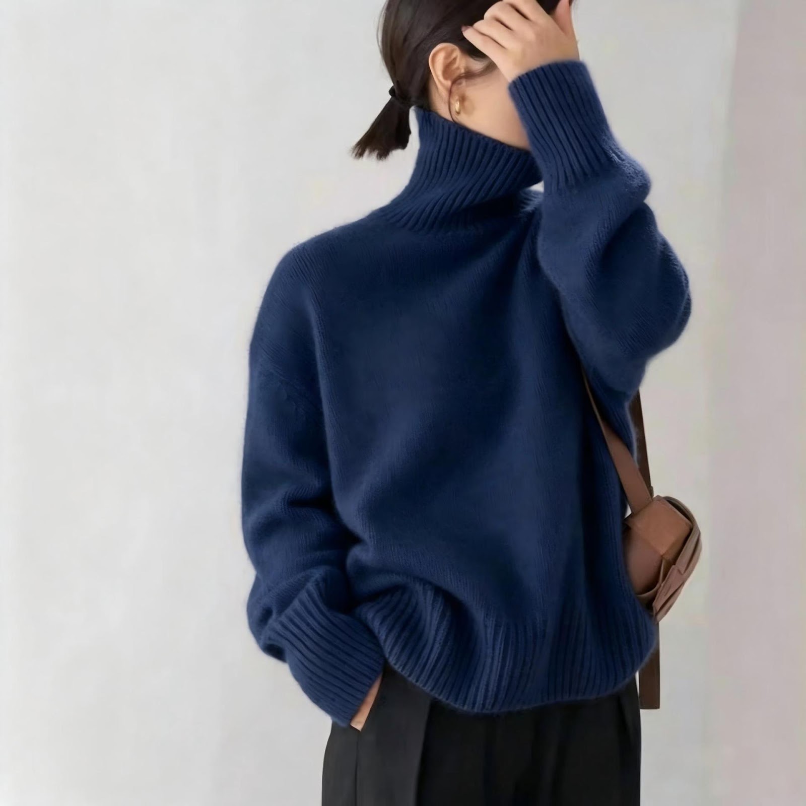 Loose women's knitted sweater with a roll neck