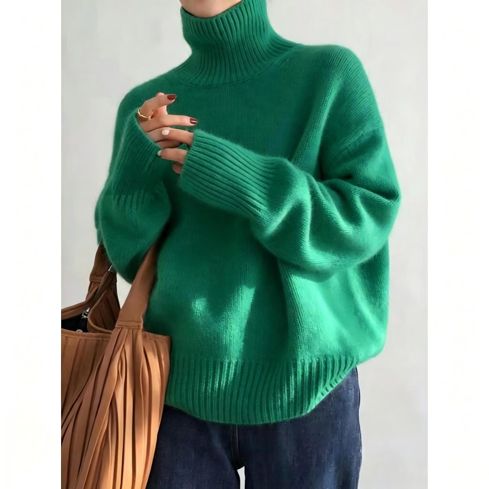 Loose women's knitted sweater with a roll neck