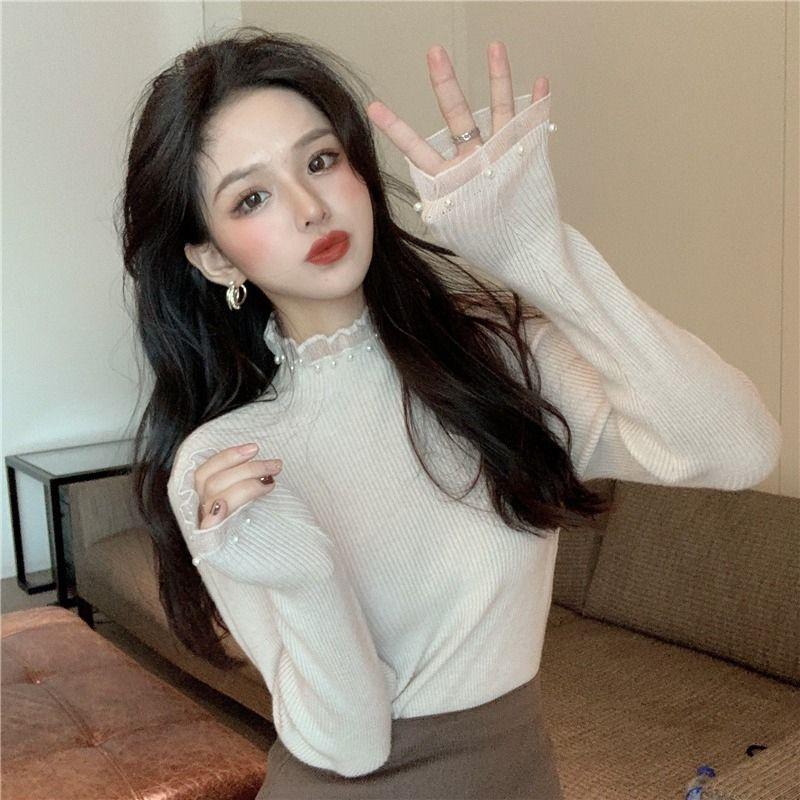 Women's knit sweater with standing collar and pearl details