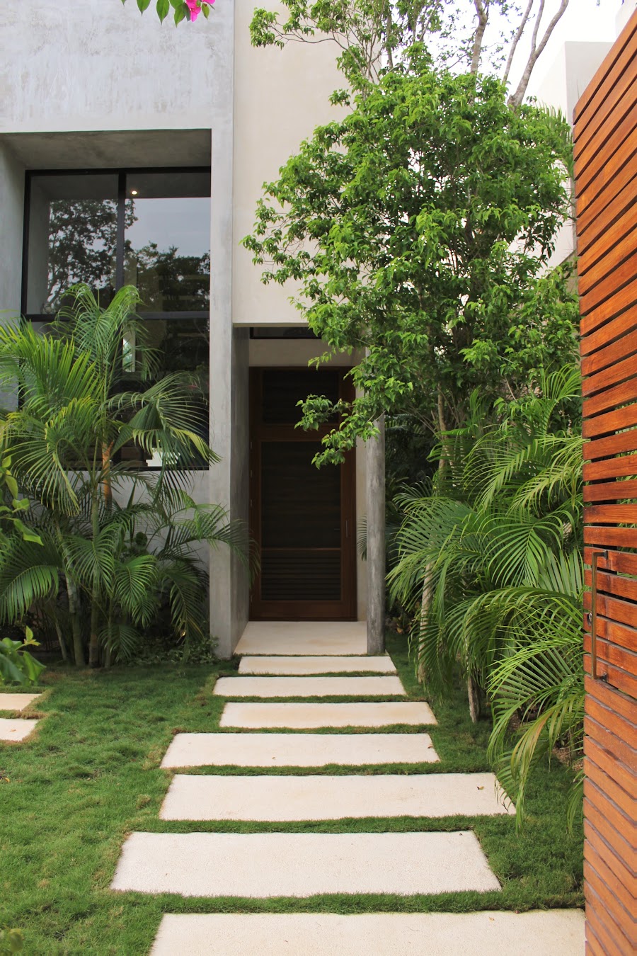 Tree-lined walkway between homes at Florafauna