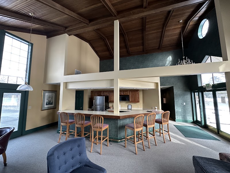 Clubhouse bar area before renovation, dated wallcoverings and finishes