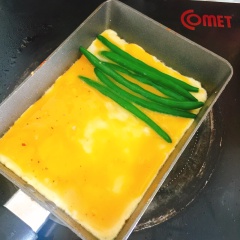 Lần lượt xếp từng lớp đậu que, thịt gà, phô mai. Đợi khi trứng vàng lớp dưới thì bắt đầu công đoạn cuộn trứng.