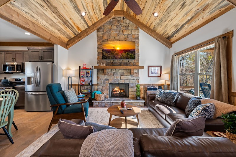 Indoor gas fireplace and living room at Orchard & Vine Mountain Haus luxury cabin Ellijay GA