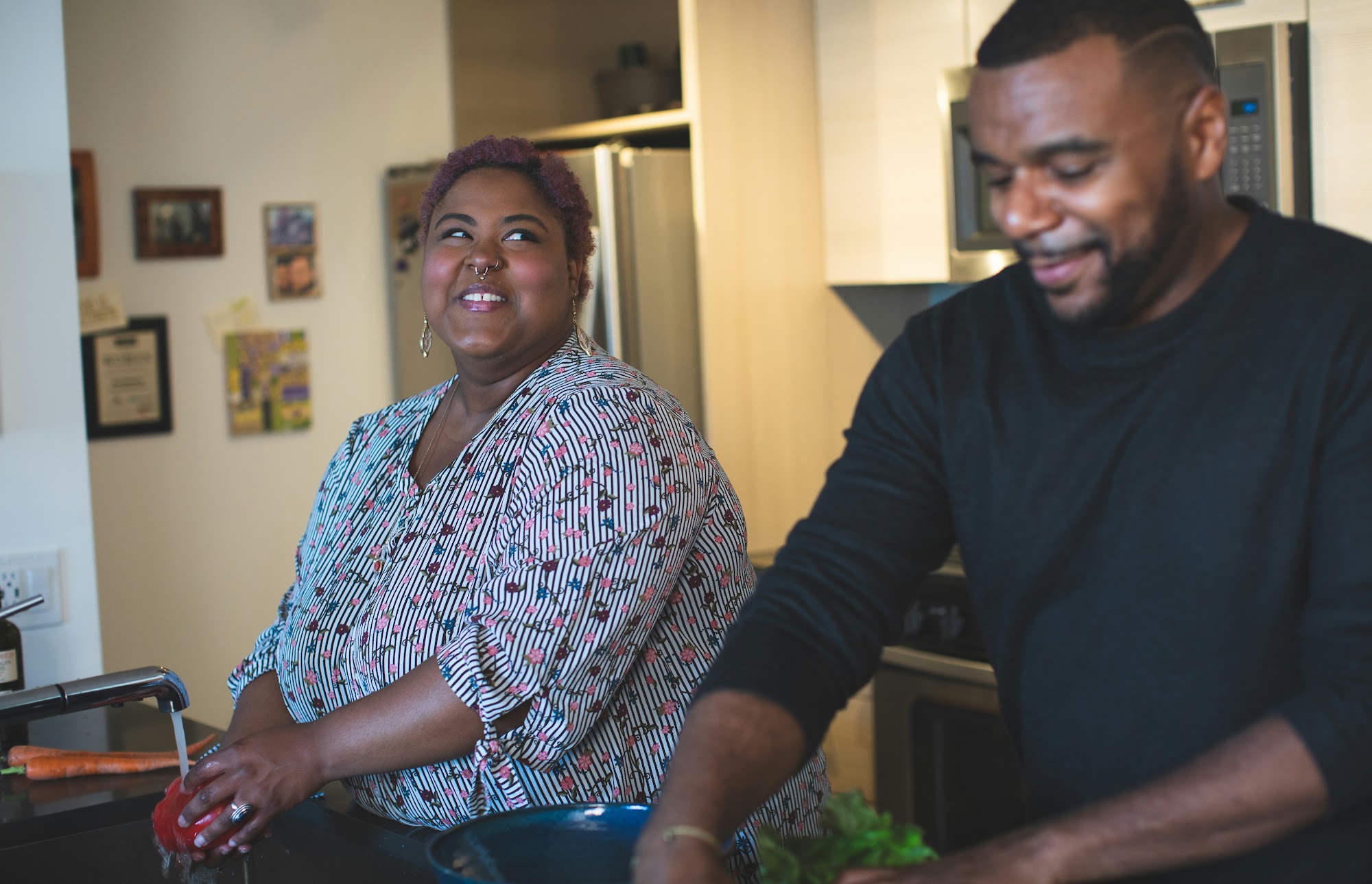 A couple preparing food together in their home kitchen