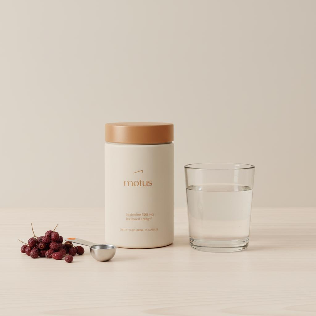 Minimalist Tonum berberine supplement bottle on wooden countertop with glass of water, dried barberry berries and a measured scoop in soft clinical lighting
