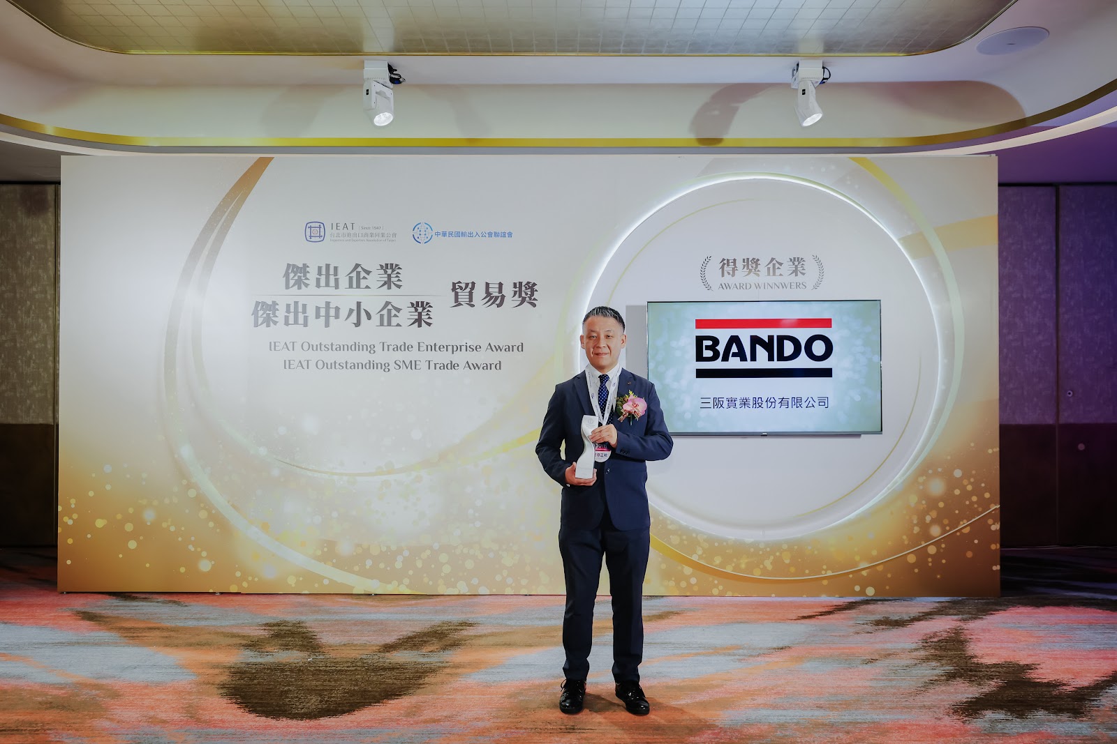 三阪實業代表於傑出中小企業貿易獎背板留影