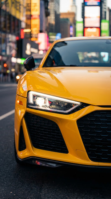 Close-Up of Yellow Sports Car Headlight on City Street - Free mobile Wallpaper