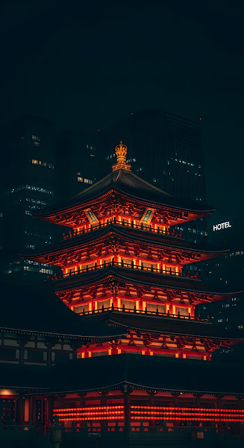 Dramatic Night View of a Traditional Singapore Buddhist Temple Against Modern City Skyline - Free mobile Wallpaper
