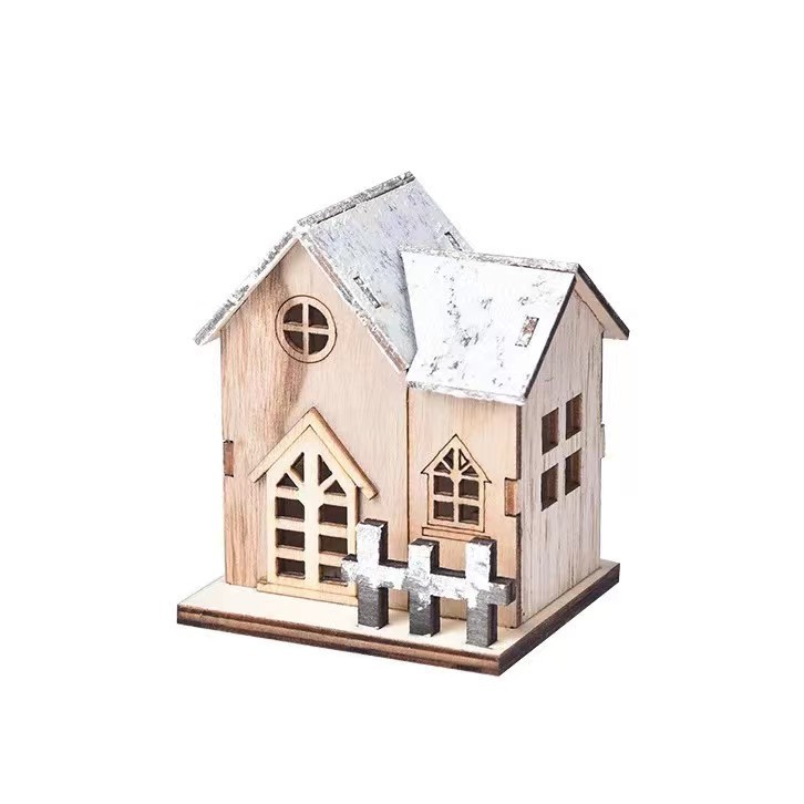 Illuminated wooden house for Christmas table decoration