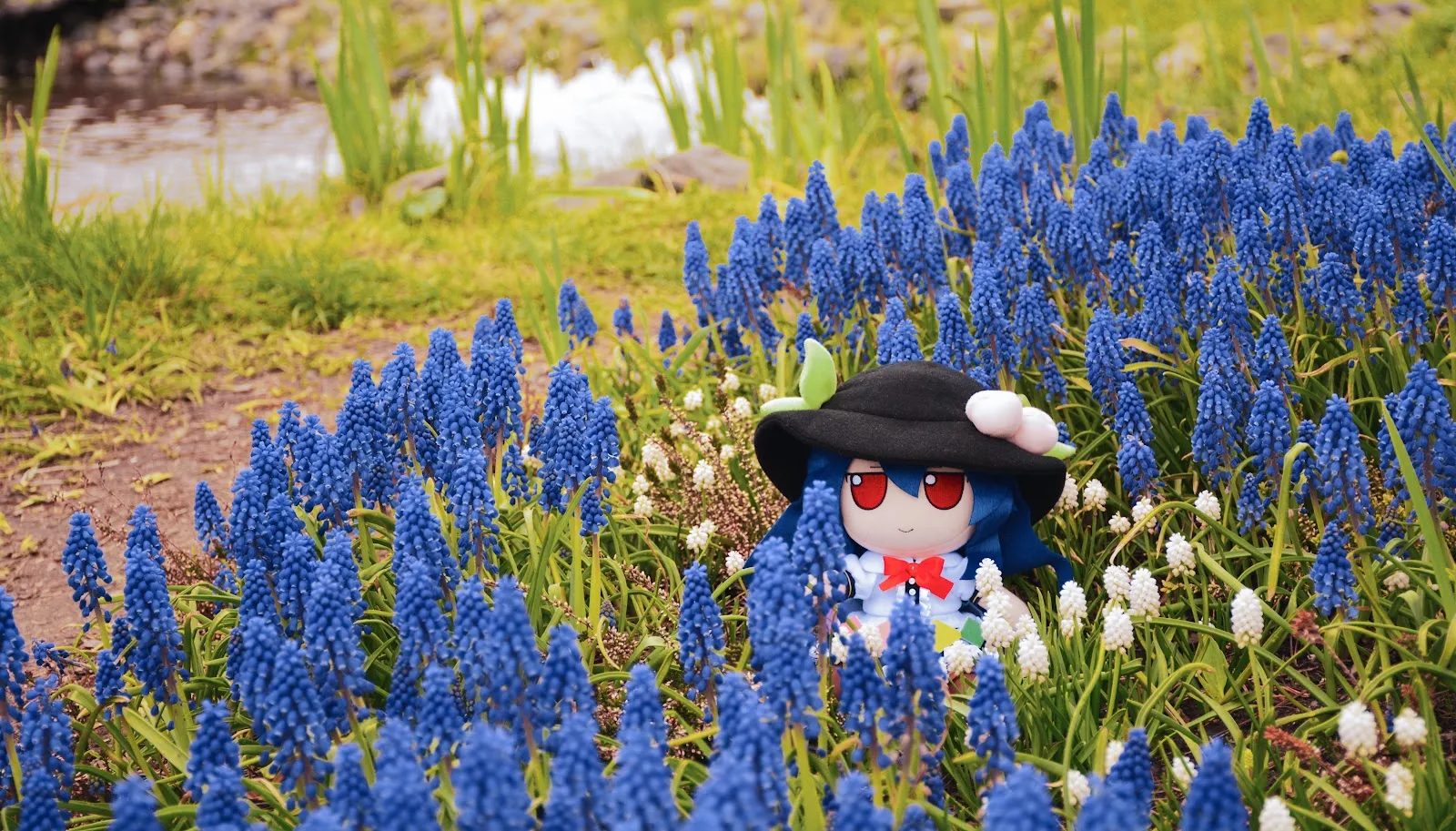 Tenshi Hinanawi Fumo in Flowers - Outdoor Toy Photography 5K Wallpaper (6000x3424)