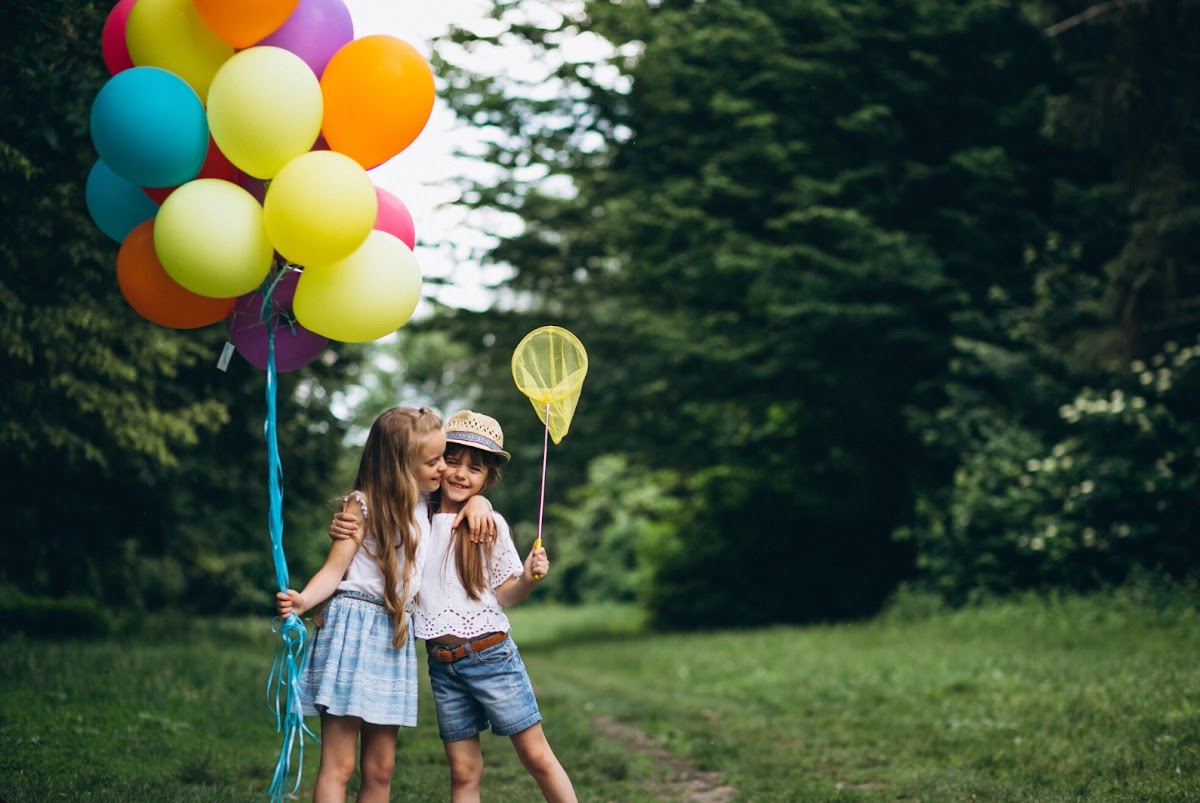 Children with balloons in a meadow