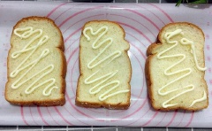Trải 3 lát bánh mì sandwich ra 1 mặt phẳng, , xịt sốt mayonasie lên, ở lát thứ 1, bạn xếp trứng và thịt xông khói lên, lát thứ 2, bạn xếp thịt xông khói và rau xà lách thái nhỏ, lát thứ 3 bạn chỉ cần xịt sốt. Lấy lát thứ 2 chồng lên lát thứ 1, lát thứ 3 úp mặt sốt xuống là hoàn thành.