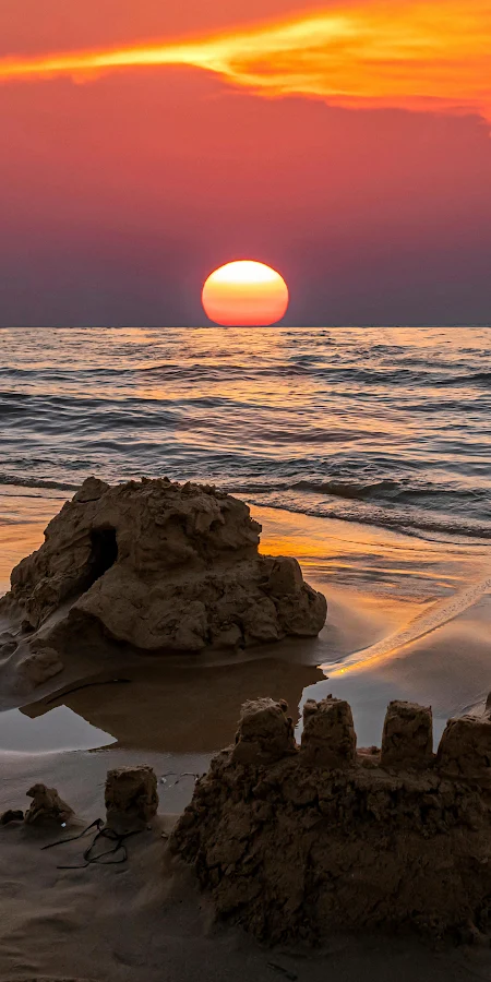 Sandcastles Under A Vibrant Sunset 2K iPhone Phone Wallpaper