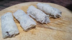 Trải lá bánh rế ra thớt, thấm nước nhẹ nhàng rồi cho nhân lên trên, cuộn lại thành cuốn chả giò.