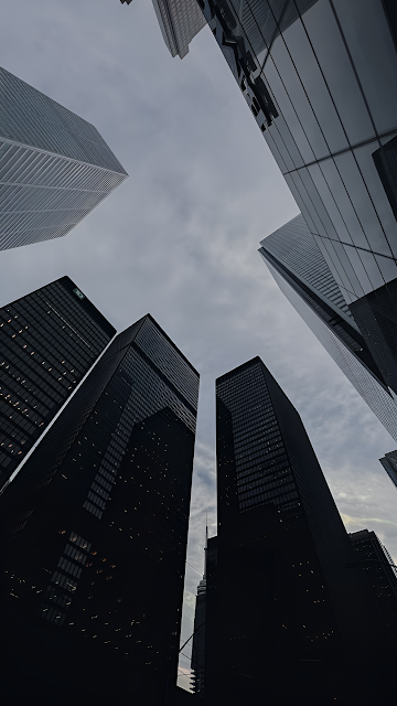 Skyscrapers Framing Cloudy Sky from Street View - Free mobile Wallpaper