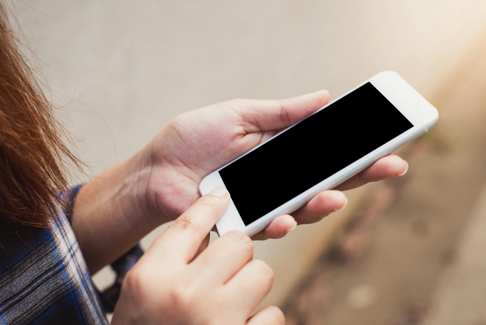 A close-up of a person typing on a smartphone, with chatbot interface elements visible, illustrating the use of AI dating apps for communication.