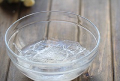 Ngâm lá gelatin trong nước lạnh cho mềm. Đu đủ rửa sạch. Cắt đôi. Dùng muỗng múc bỏ phần hạt.