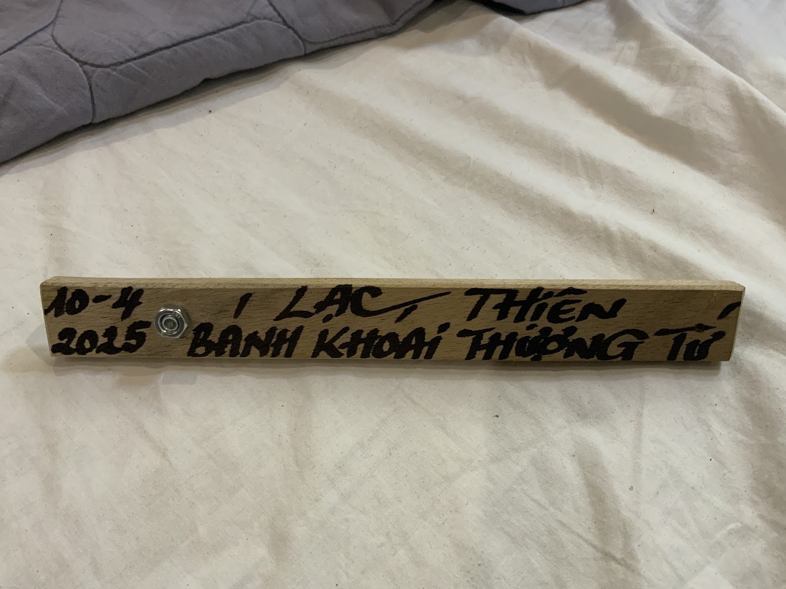 A piece of wood with the address of a restaurant on it