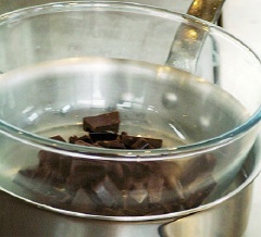 Chocolate đen hấp cách thủy cho tan chảy. Dùng máy đánh trứng, đánh đều kem tươi, trứng gà, đường trắng trong 1 cái tô.