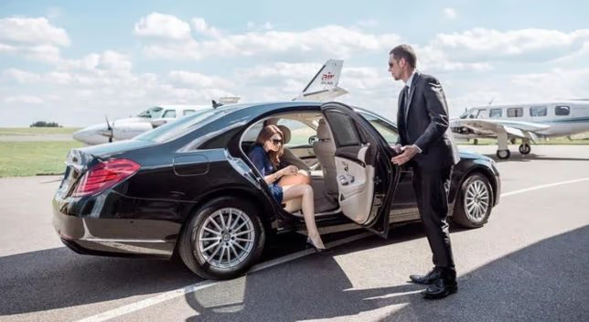 Chauffeur receiving passengers at the aircraft steps
