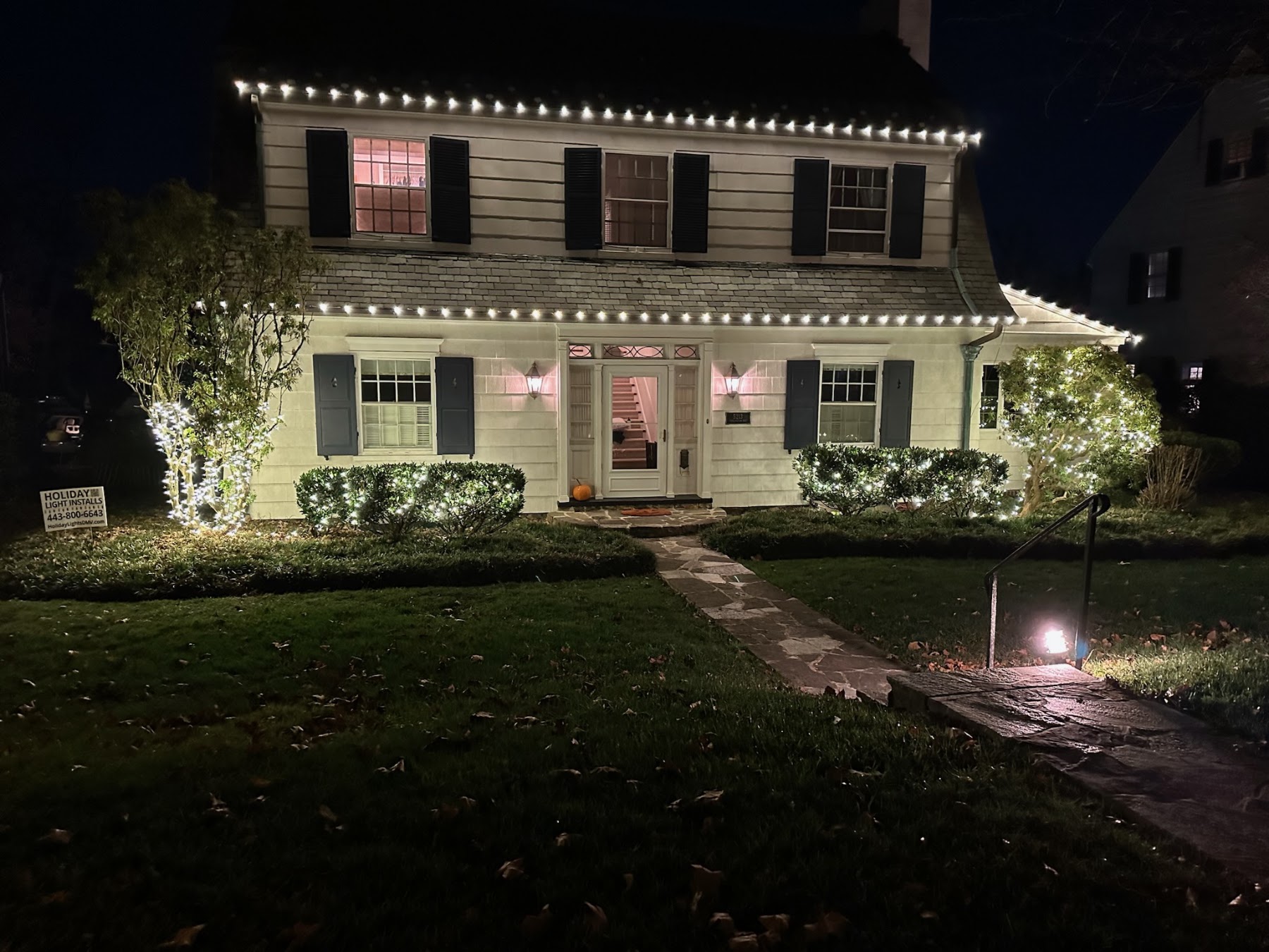 Real completed warm-white roofline, shrub and ornamental tree lighting