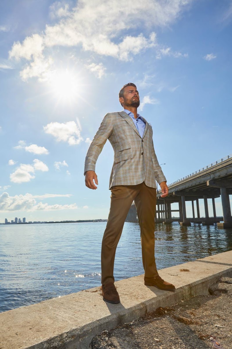 Close up detail of a tan and beige plaid summer blazer highlighting breathable textured fabric suitable for a daytime wedding.