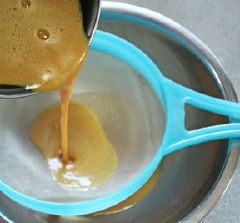 Khi hỗn hợp sôi, cho gelatine đã ngâm vào nồi, khuấy tan rồi tắt bếp. Dùng rây lược sơ qua để loại bỏ những phần lợn cợn.