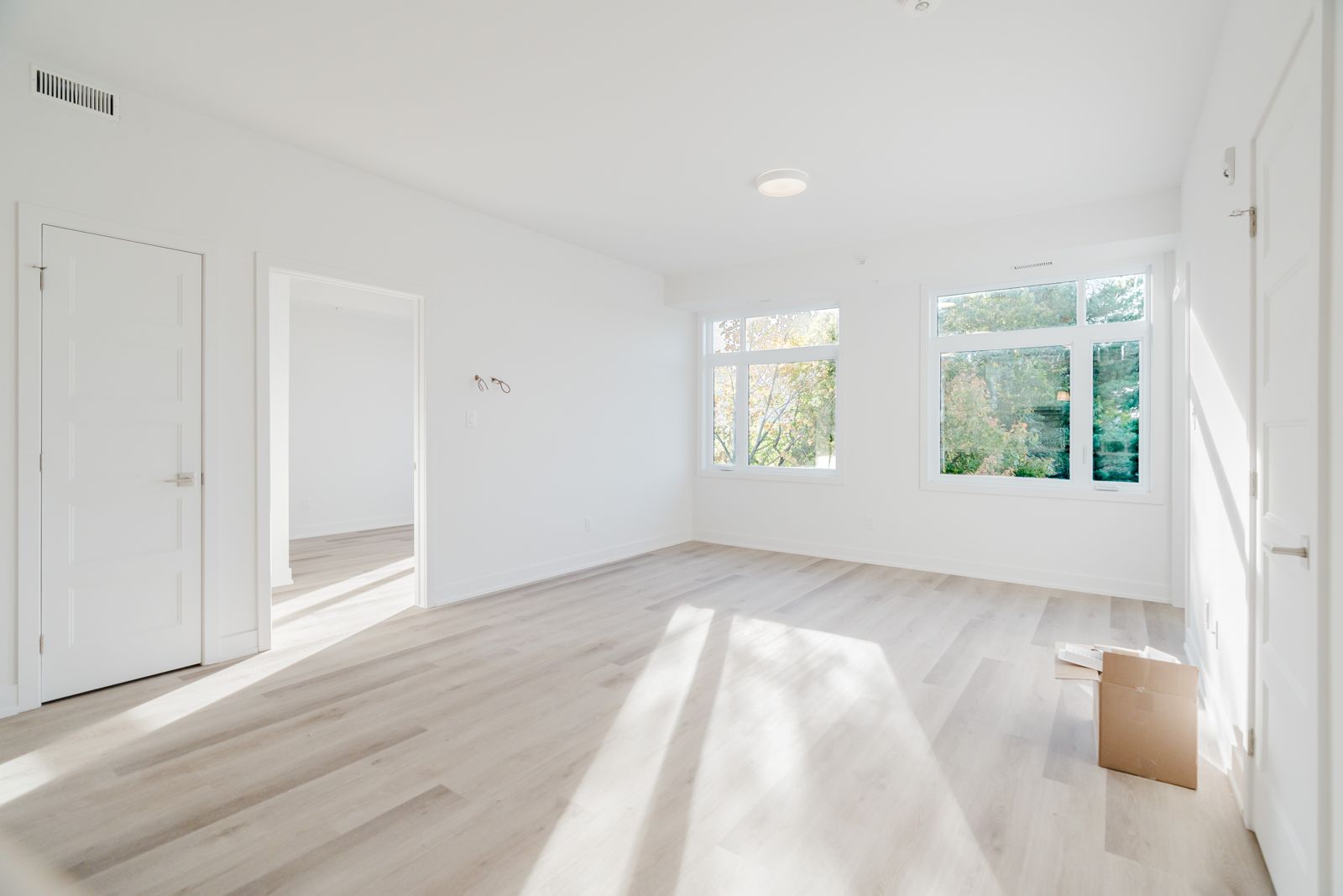 Bright, empty living room with large windows