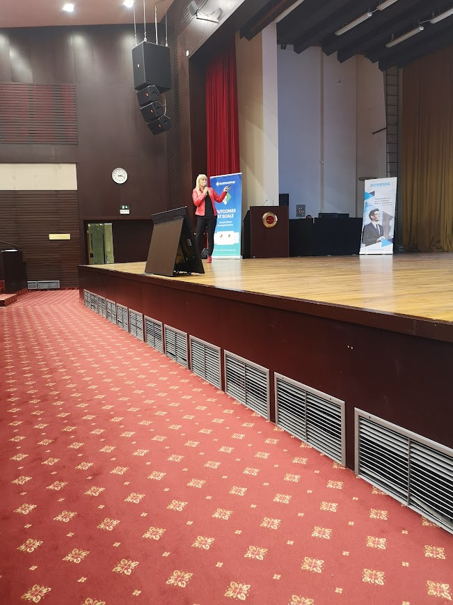 Sue speaking at a conference