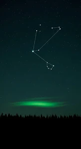 The Big Dipper Constellation Over a Silhouetted Forest and Glowing Night Sky