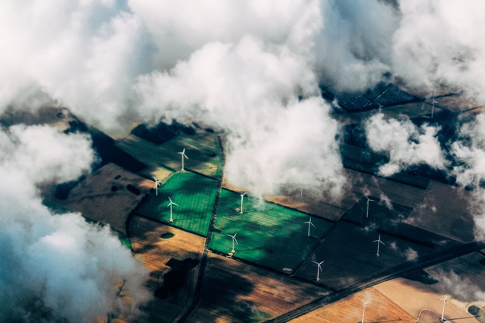 Sky high clouds overlooking fields of wind turbines