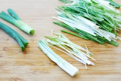 Chọn những nhánh hành tươi. Dùng dụng cụ để cắt hành thành những sợi thật nhỏ, thật mỏng, cả phần đầu và phần lá. Đem hành đã cắt nhỏ đi ngâm khoảng 10 phút, sau đó để ráo.