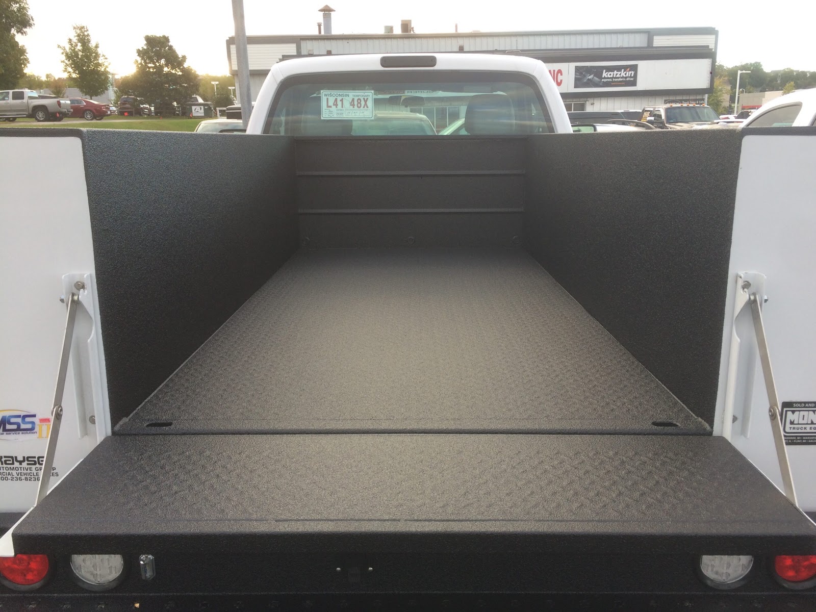 Service body truck bed coated with textured protective liner