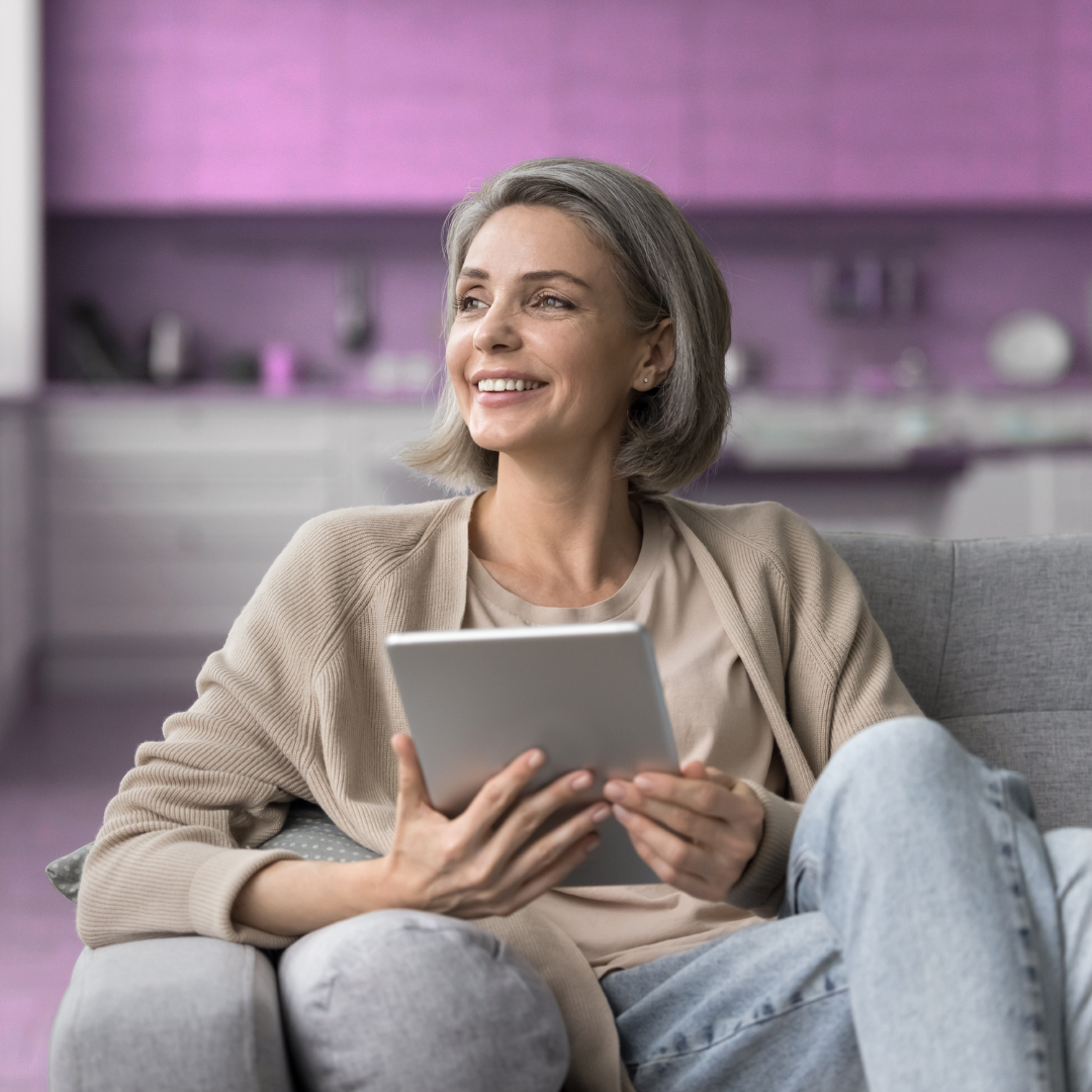A woman using IndiAide on a tablet at home