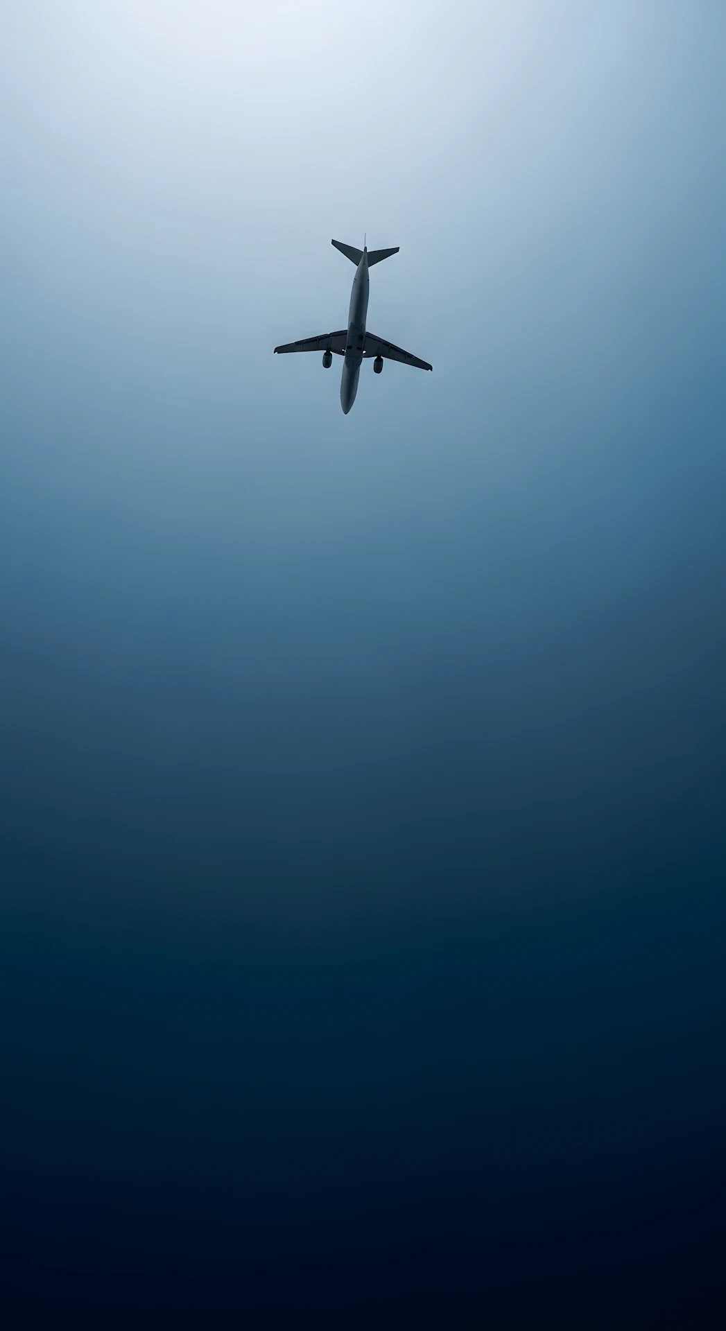 Commercial Jet Silhouette Against Deep Blue Gradient Sky - Free 4K mobile Wallpaper