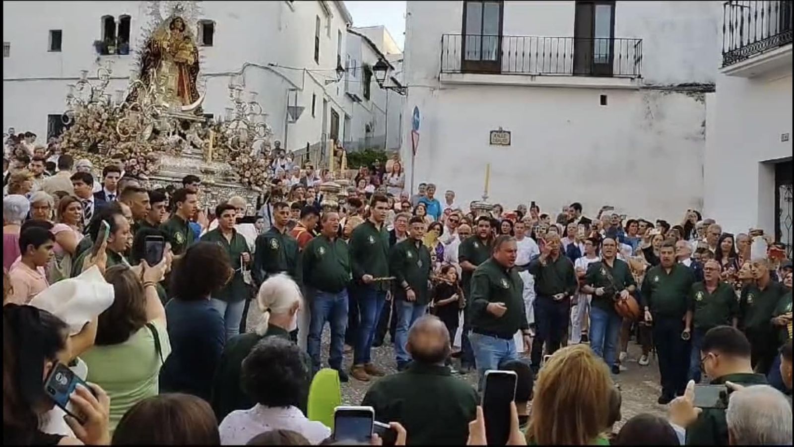 Campanilleros of different ages sing and play traditional instruments together in the streets of Aracena.