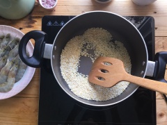 Bật bếp, đợi chảo nóng cho gạo vào rang đến khi có màu nâu vàng. Tiếp theo, nấu sôi 1,5 lít nước lọc và nước luộc tôm và cho gạo đã rang vàng vào nấu đến khi nở ra.
