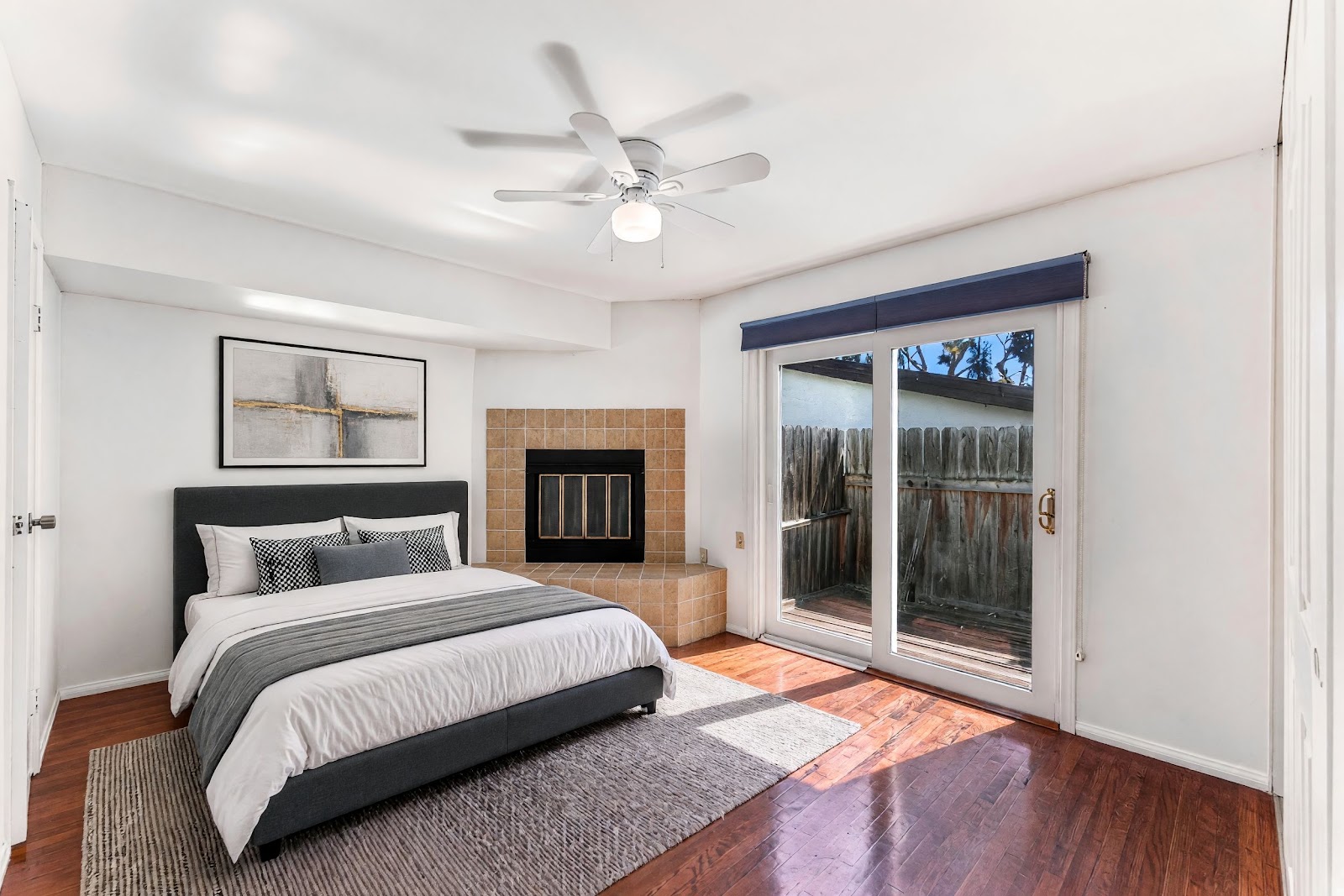 Primary bedroom with fireplace and slider to the backyard