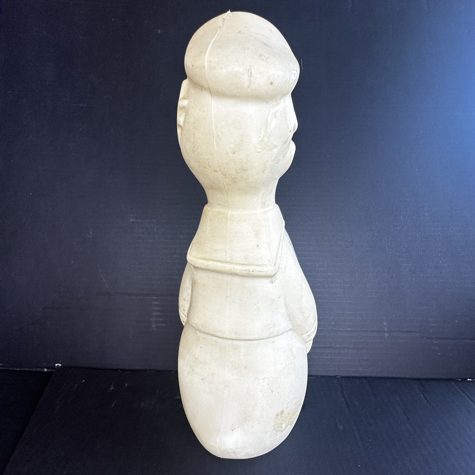 Vintage blow-molded hard plastic Donald Duck bank, back view, showing sailor hat and collar, cream-yellowed plastic with paint loss, circa late 1950s to early 1960s