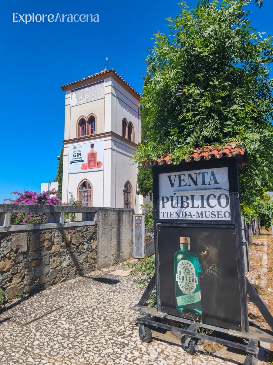 Exterior of the Martes Santos Distillery museum and public shop surrounded by trees near Aracena.