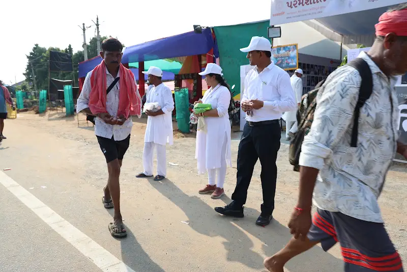 Padyatris walk past the Paramshanti camp.