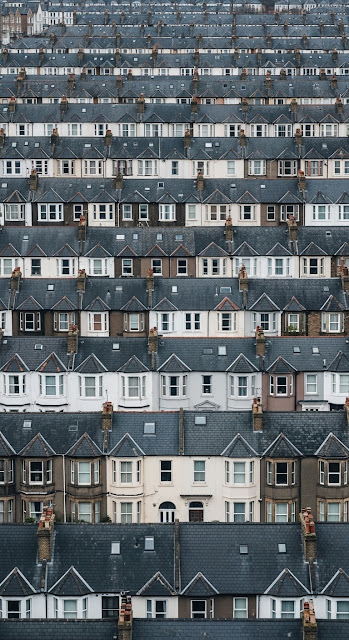 High Aerial View of Dense, Repetitive Rows of European Terraced Rooftops and Houses - Free mobile Wallpaper