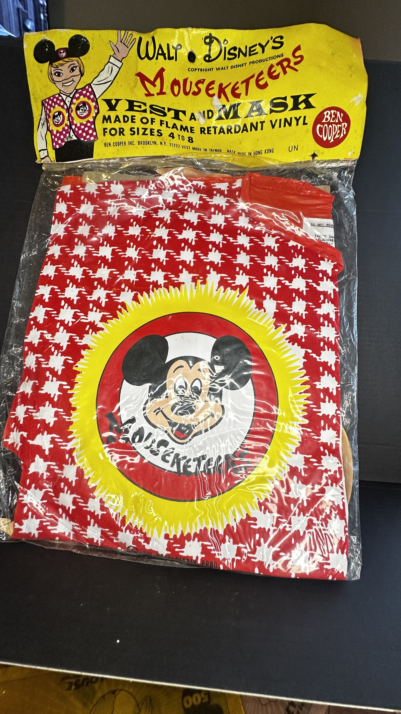 Vintage Ben Cooper Mickey Mouse Club Mouseketeers costume set in sealed original polybag with header card, showing red white and yellow vinyl vest with Mickey face graphic
