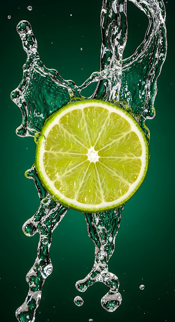 Fresh Lime Slice with Dynamic Water Splash on Green - Free mobile Wallpaper