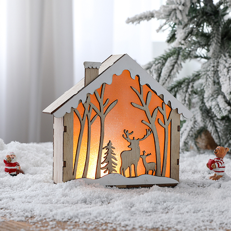 Illuminated wooden Christmas house in Scandinavian style