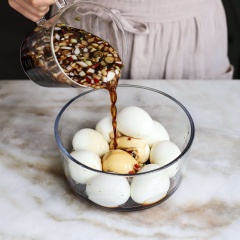 Trong một ca lớn, cho vào 240ml nước tương, 360ml nước lọc, 100g đường, hành tây, hành lá và ớt đã thái vào, khuấy đều lên. Cho trứng đã bóc vỏ vào tô lớn, rót hỗn hợp vừa pha vào ngập trứng, để yên trong ngăn mát tủ lạnh khoảng 2-4 tiếng đồng hồ là có thể dùng.